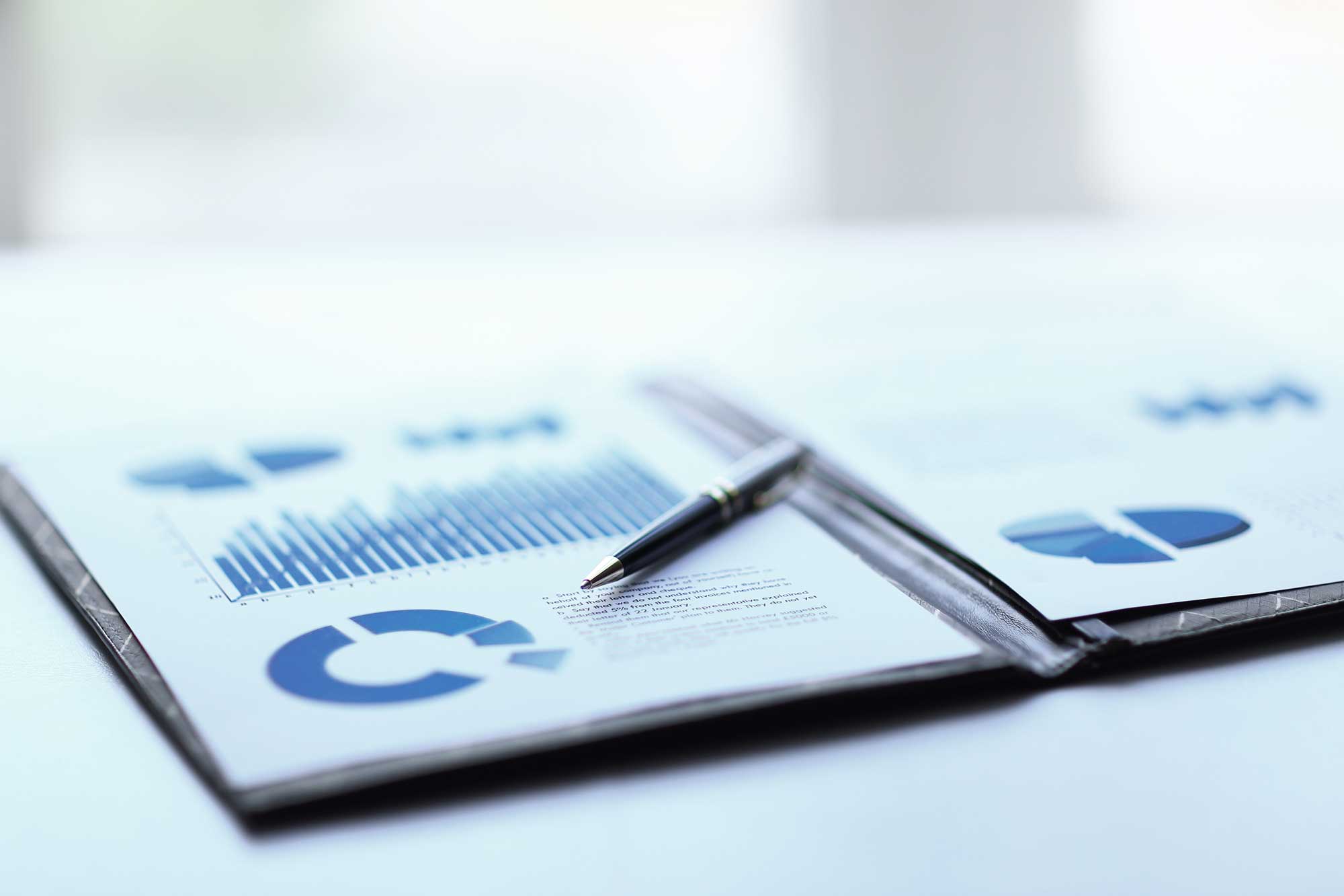 investment-docs-pen-blurred-background